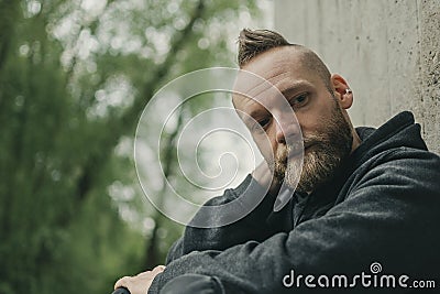 Young man sitting on the ground Stock Photo