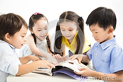 Happy school kids studying together Stock Photo