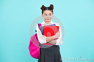Happy school teenage girl with book and copybook. Teenager schoolgirl student, blue background. Learning and Stock Photo
