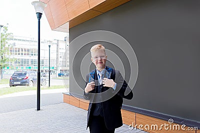 Happy schoolboy walks down the street, back to school Stock Photo