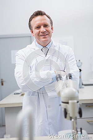 Happy scientist looking at camera with arms crossed Stock Photo