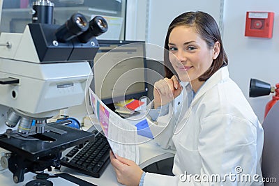 Happy scientist smiling at camera in laboratory Stock Photo