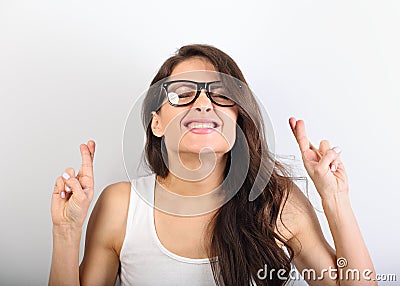 Happy screwing up eyes beautiful woman in glasses crossing her f Stock Photo