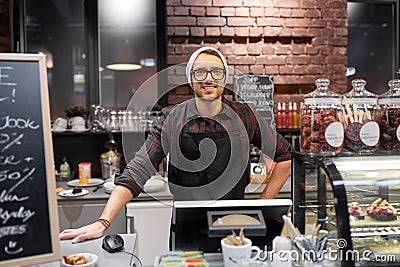 Happy seller man or barman at cafe counter Stock Photo