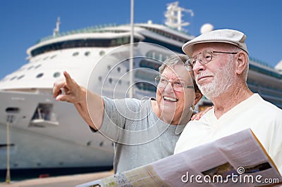 Happy Senior Adult Couple Tourists with Brochure by Cruise Ship Stock Photo