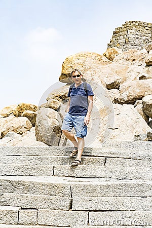 Happy Senior Adult man Tourist clumbing up the steps at Gingee, Tamil Nadu, India Editorial Stock Photo