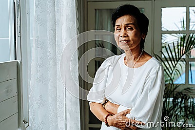 Happy senior Asian woman resting at home Stock Photo