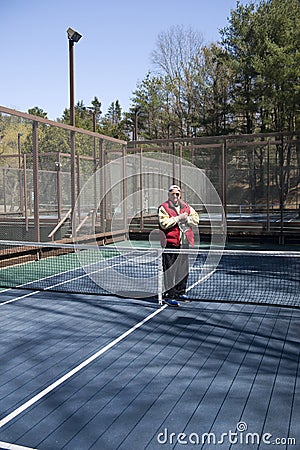 Happy senior athlete platform tennis paddle court Stock Photo