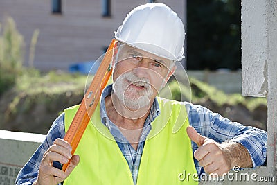 Happy senior construction worker looking at camera Stock Photo