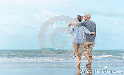 Happy senior couple on the beach. Exotic luxury resort.back view Stock Photo