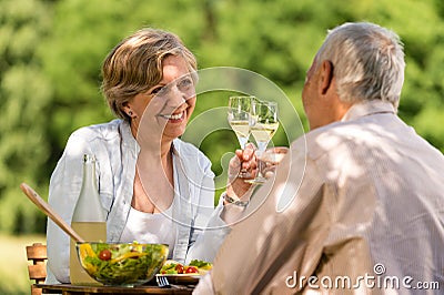 Happy senior couple clinking glasses Stock Photo