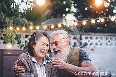 Happy senior couple having fun at dinner house party Stock Photo