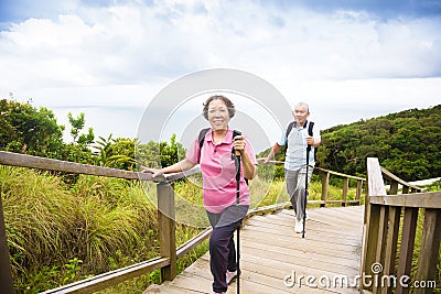 Happy senior couple hiking on the mountain park Stock Photo