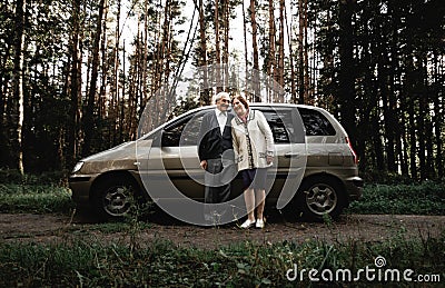 Happy senior couple with new car Stock Photo