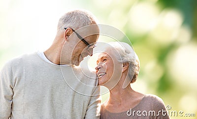 Happy senior couple over green natural background Stock Photo