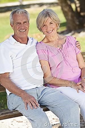 Happy Senior Couple Smiling Outside in Sunshine Stock Photo