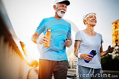 Happy senior couple staying fit by sport running Stock Photo