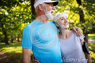 Happy senior couple staying fit by sport running Stock Photo