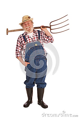 Happy senior farmer lifting hay fork up Stock Photo