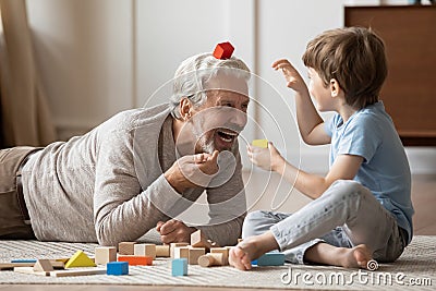 Happy senior grandfather play with small grandson Stock Photo