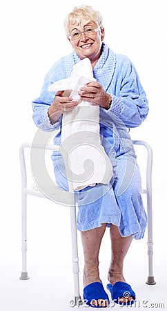 Happy senior lady on shower seat Stock Photo