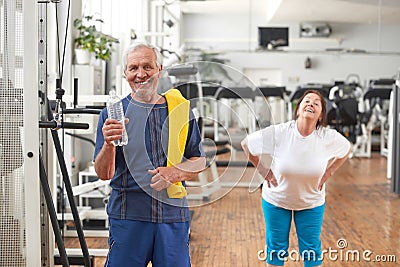 Happy senior man with bottle of water at gym. Stock Photo