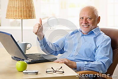 Happy senior man giving thumb up Stock Photo