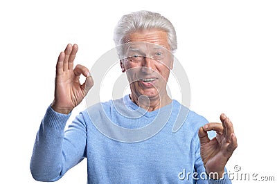 Happy senior man showing ok signs on white background Stock Photo