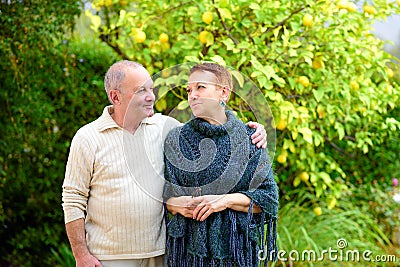 Happy senior man and woman hugged, enjoying beautiful sunny day outside together. Stock Photo