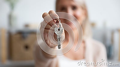 Happy senior woman customer hold key to new house, closeup Stock Photo