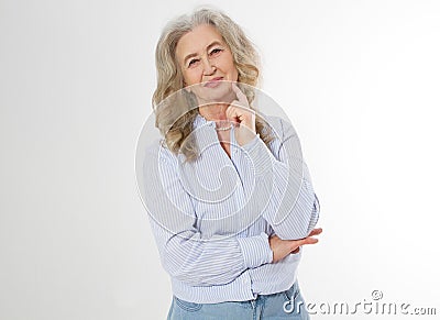Happy senior woman with crossed arms isolated on white background. Positive elderly seniors life living and european old beauty Stock Photo