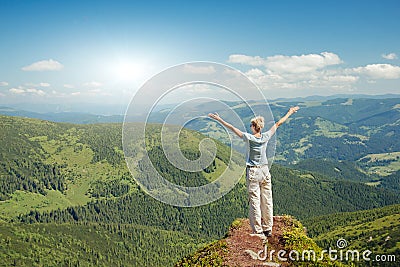 Happy senior woman enjoying the nature in the mountains Stock Photo