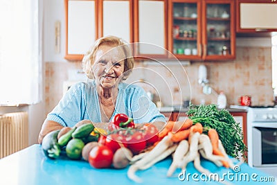 Happy senior woman with fresh crop from her garden Stock Photo