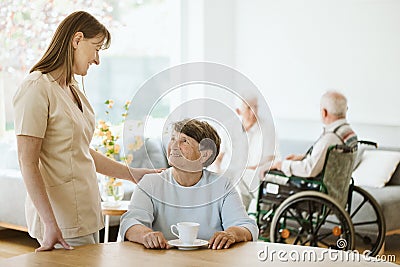 Senior woman and helpful caregiver, nursing home concept photos Stock Photo