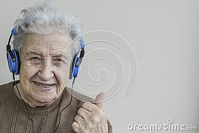 Happy senior woman listening music with headphones Stock Photo