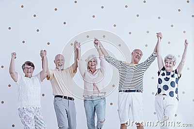 Happy seniors jumping Stock Photo