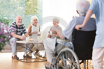 Seniors visiting their friend Stock Photo