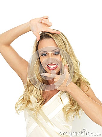 Happy Young Woman Posing By Framing Her Face With Her Hands Stock Photo