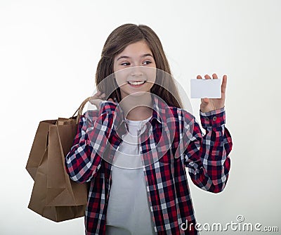 Happy shopper holding discount white card and shopping bags and carton boxes in her hands. Young girl with credit card. Stock Photo