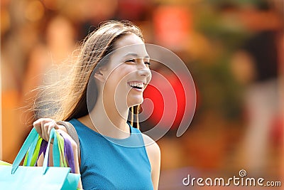 Happy shopper with shopping bags walking Stock Photo