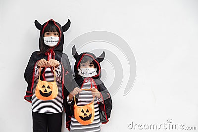 Happy sibling girls at the halloween party. children wearing costumes halloweens. concept of children ready for a party Stock Photo