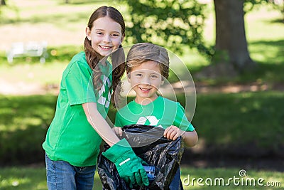 Happy siblings collecting rubbish Stock Photo