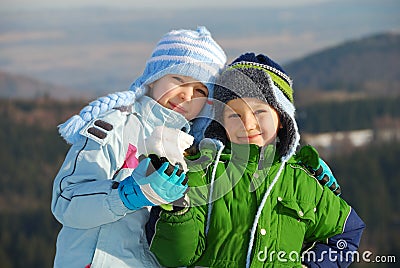 Happy siblings with snow Stock Photo