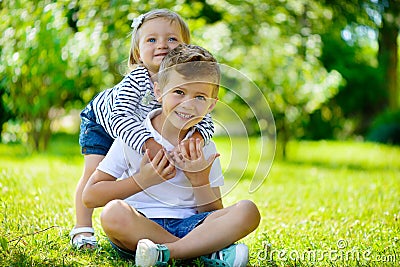 Happy sister and brother together in park Stock Photo