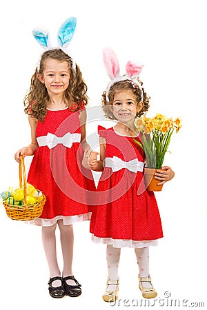 Happy sisters with bunny ears and easter eggs Stock Photo