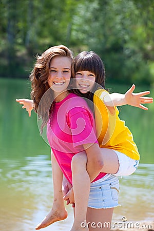 Happy sisters by lake Stock Photo