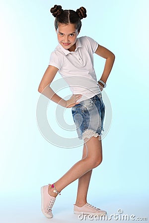 Happy slender child girl full growth in denim shorts with bare legs Stock Photo