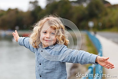 Happy child with long blond hair enjoying the holidays Stock Photo