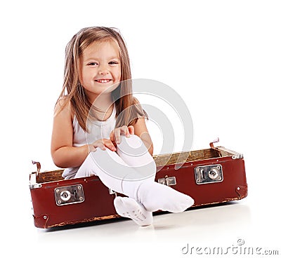 Happy small child sitting in a suitcase. Travel Stock Photo