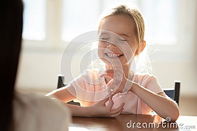 Happy small girl child have fun talking with mom Stock Photo